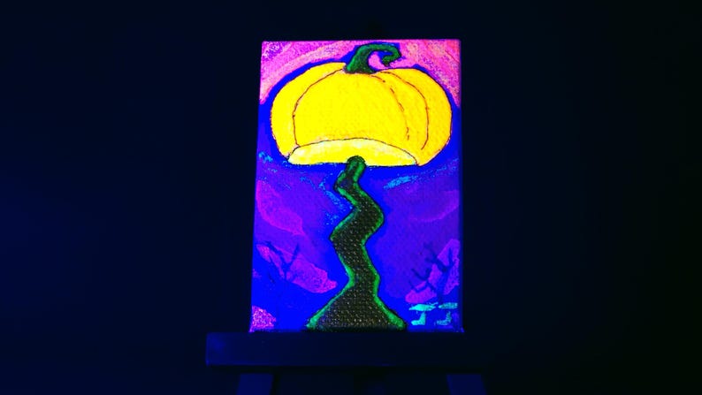 Pumpkin mushroom painted on a 2x3 inch canvas, shown on its mini easel